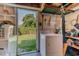 Utility basement with open door to fenced yard, washer and dryer at 1615 Crestwood Dr, Orlando, FL 32804