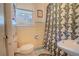 Quaint bathroom featuring vintage fixtures, a patterned shower curtain and natural light at 1615 Crestwood Dr, Orlando, FL 32804