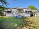 Charming single-story home featuring a covered porch and yellow front door at 1615 Crestwood Dr, Orlando, FL 32804