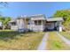 Charming home with a tidy lawn, carport, and cozy front porch at 1615 Crestwood Dr, Orlando, FL 32804