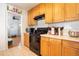 Cozy kitchen featuring wooden cabinets, stainless appliances, and white tile backsplash at 1615 Crestwood Dr, Orlando, FL 32804