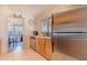 Bright kitchen with stainless steel appliances, wooden cabinets, and tiled floors at 1615 Crestwood Dr, Orlando, FL 32804
