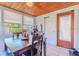 Inviting sunroom featuring wood ceilings, a dining table, and a door to the outside at 1615 Crestwood Dr, Orlando, FL 32804