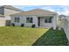 The backyard features a well-maintained lawn, privacy fence, and covered patio at 1773 Groveline Rd, St Cloud, FL 34771