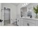 Well-lit bathroom with double sink vanity, quartz countertop, tile floor and walk-in closet at 1773 Groveline Rd, St Cloud, FL 34771