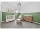 Charming Bedroom featuring a crib, rocking chair, and modern decor at 1773 Groveline Rd, St Cloud, FL 34771