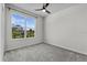Bright bedroom with a large window, gray carpet and ceiling fan at 1773 Groveline Rd, St Cloud, FL 34771