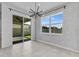 Elegant dining area with a modern chandelier and a sliding glass door at 1773 Groveline Rd, St Cloud, FL 34771