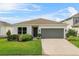 Charming single-story home with a well-maintained lawn, and a two car garage at 1773 Groveline Rd, St Cloud, FL 34771