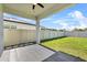 Cozy covered patio overlooking a well maintained, fenced backyard with lush green grass at 1773 Groveline Rd, St Cloud, FL 34771