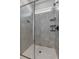 Modern walk-in shower with gray tile, glass door, and a built-in niche at 1773 Groveline Rd, St Cloud, FL 34771
