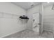 Spacious walk-in closet with ample shelving and an adjacent bathroom featuring a double vanity sink at 1773 Groveline Rd, St Cloud, FL 34771