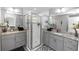 Modern bathroom with dual sinks, granite countertops, and a glass-enclosed walk-in shower at 1857 E Cooper Dr, Deltona, FL 32725