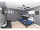 Bedroom with bunkbeds, light and fan, painted grey with colorful decor at 1857 E Cooper Dr, Deltona, FL 32725