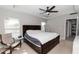 Bright bedroom featuring a tray ceiling, ceiling fan, and neutral décor for a calming space at 1857 E Cooper Dr, Deltona, FL 32725