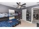 bedroom featuring bunk beds, ceiling fan, and creative wall decor for an inspiring space at 1857 E Cooper Dr, Deltona, FL 32725