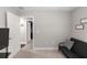 Empty carpeted room with a futon and two doors and walls painted light gray at 1857 E Cooper Dr, Deltona, FL 32725