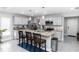 Bright, neutral kitchen featuring a spacious island, stainless steel appliances, and sleek cabinetry at 1857 E Cooper Dr, Deltona, FL 32725
