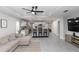 Open-concept living space seamlessly connecting the living room and kitchen, featuring neutral decor at 1857 E Cooper Dr, Deltona, FL 32725