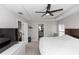 Serene main bedroom with tray ceiling, ceiling fan, neutral colors, and access to ensuite bathroom at 1857 E Cooper Dr, Deltona, FL 32725