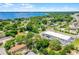 Aerial view showcasing the property with a pin marker, set against the backdrop of a lake and lush greenery nearby at 201 W Washington St, Minneola, FL 34715