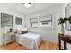 Sunlit bedroom featuring three windows, hardwood floors, and neutral decor at 205 W Princeton St, Orlando, FL 32804
