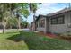 Exterior view showing the side of the house with a brick chimney and surrounding green grass at 205 W Princeton St, Orlando, FL 32804