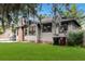 View of the house from the back yard showing the porch, brick chimney, and fenced yard at 205 W Princeton St, Orlando, FL 32804