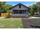 Charming home featuring a cozy front porch, manicured lawn, and tasteful landscaping at 205 W Princeton St, Orlando, FL 32804
