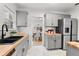 Modern kitchen with gray cabinets, butcher block countertops, and stainless steel appliances at 205 W Princeton St, Orlando, FL 32804