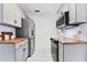 Efficient kitchen featuring modern appliances, butcher block countertops, and white subway tile at 205 W Princeton St, Orlando, FL 32804