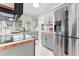Bright kitchen with stainless steel refrigerator, butcher block countertops, and gray cabinetry at 205 W Princeton St, Orlando, FL 32804