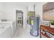 Laundry area with washer, dryer, and water heater; marble tile flooring at 205 W Princeton St, Orlando, FL 32804