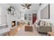 Bright living room with a decorative fireplace, ceiling fan, and hardwood floors at 205 W Princeton St, Orlando, FL 32804