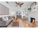 Cozy living room with hardwood floors, a fireplace, and an archway leading to the dining area at 205 W Princeton St, Orlando, FL 32804