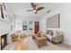 Bright living room with a decorative fireplace, ceiling fan, and hardwood floors at 205 W Princeton St, Orlando, FL 32804