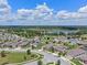 An aerial view of a single-Gathering home in a residential neighborhood with a lake nearby at 209 Luxmore Rd, Groveland, FL 34736