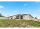 Expansive backyard with a well-maintained lawn and screened patio offering outdoor relaxation at 209 Luxmore Rd, Groveland, FL 34736