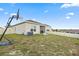 Backyard with a grass lawn, creating a great outdoor space for relaxation and activities at 209 Luxmore Rd, Groveland, FL 34736