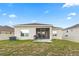 Lush backyard featuring a patio area, providing ample space for outdoor activities and enjoyment at 209 Luxmore Rd, Groveland, FL 34736