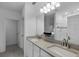 Bright bathroom with double sinks, large mirror, and walk-in shower with tiled accents at 209 Luxmore Rd, Groveland, FL 34736