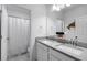 Bathroom featuring double sinks and a shower tub combo with tiled walls and neutral tones at 209 Luxmore Rd, Groveland, FL 34736