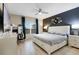 Spacious bedroom with a decorative accent wall, a large bed, and a dedicated workspace at 209 Luxmore Rd, Groveland, FL 34736