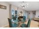 Dining room featuring a glass table, stylish light fixture, and views of the outdoor patio at 209 Luxmore Rd, Groveland, FL 34736