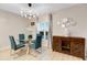 A brightly lit dining room features views from a window, a decorative accent wall, and an ornate cabinet at 209 Luxmore Rd, Groveland, FL 34736