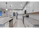Modern kitchen featuring white cabinets, stainless steel appliances, and a large island with a sink at 209 Luxmore Rd, Groveland, FL 34736