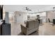 Open-concept space with wood floors, connecting the living area, kitchen, and dining space for easy living at 209 Luxmore Rd, Groveland, FL 34736