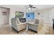 Spacious living area with light wood floors, modern furniture, and a view into the adjacent kitchen and dining area at 209 Luxmore Rd, Groveland, FL 34736