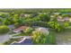 Real estate aerial view showing a home featuring a brick driveway, surrounded by mature trees and landscaping at 215 Juniper Ridge Ct, Sanford, FL 32771