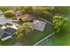 Aerial view of a charming home with mature trees, a well-manicured lawn, and a private backyard at 215 Juniper Ridge Ct, Sanford, FL 32771